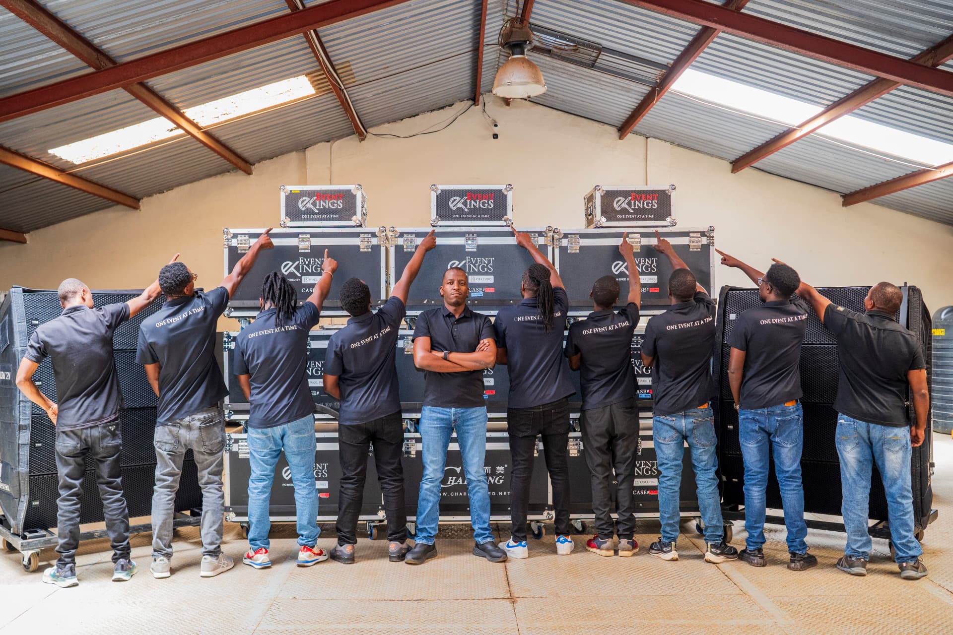 Event Kings production team standing together in front of stacked flight cases
